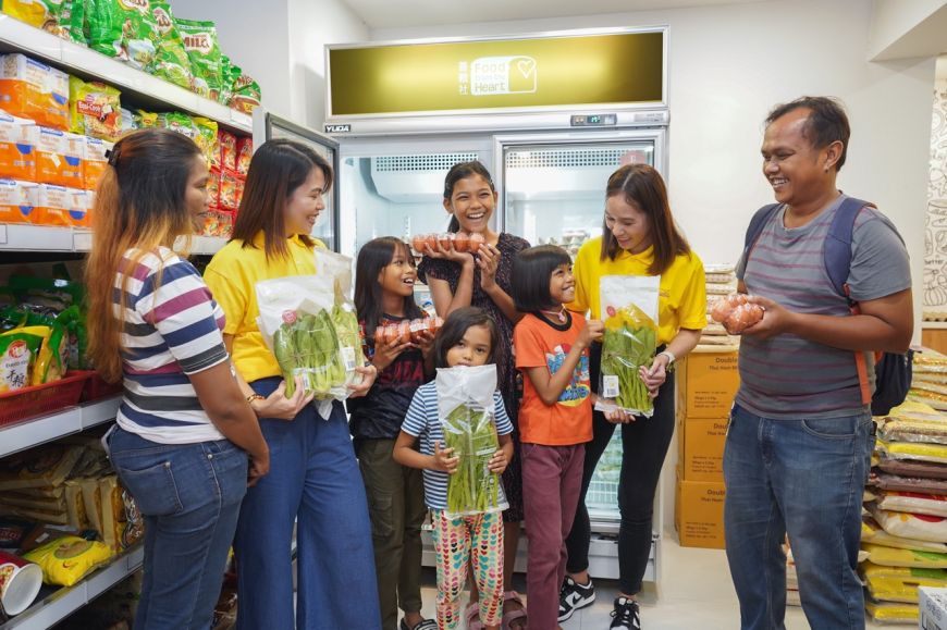 RWS staff volunteers accompanying Mdm Rosninah’s family to select fresh and nutritious food items at the Community Shop in Boon Lay